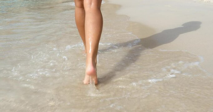 CU TS Rear view of woman's legs walking on beach / La Maddalena island, Sardinia, Italy