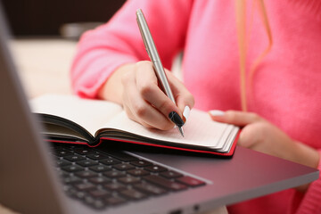 woman study hard write down information to notebook education concept