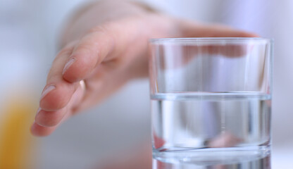 Male arm stretching out to glass in office closeup