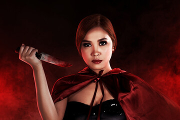 Asian witch woman holding a bloody knife
