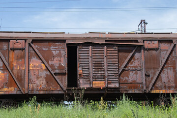 old rusty freight car stands on rails in Ukraine