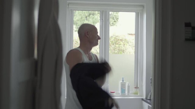 MS Man dressing up in bathroom / Denmark