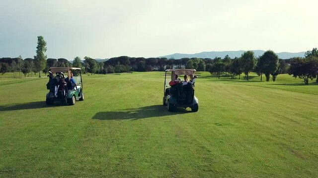 AERIAL WS People in golf carts in golf course / Prato, Florence, Italy