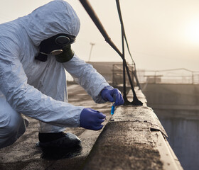 Scientist conducting laboratory test using tweezers and blue reagent in glass flask outdoors,...