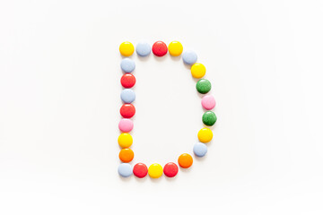 Candies font alphabet. Letter D isolated top view