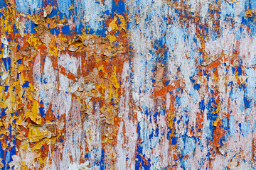 Minimalist colourful textured background of old and rusted whit, blue, brown and orange  paing on metallic surface, in direct sun light in an urban environment.