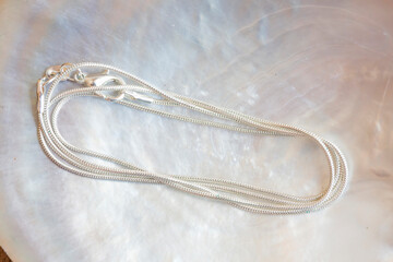 White metal sterling silver chain snake style on white shell background
