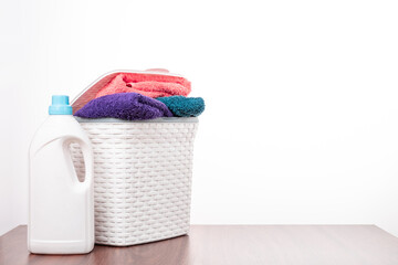 Linen, towel, washing liquid powder, laundry detergent on a white background. Front view with copy space. The subject of washing clothes, clothing care and homework.