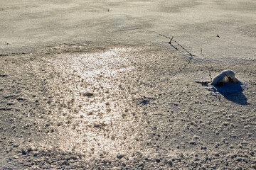 Snow or ice texture or background outdoors in a winter day. Nature landscape with frozen water on a lake or river in the cold and sun.