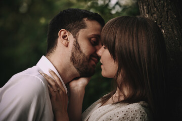 Naklejka premium A guy and a girl are walking in the park. Romantic date evening walk. The relationship between people is love and tenderness.