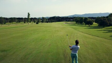AERIAL WS Men playing golf on sunny day / Prato, Florence, Italy