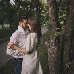 A guy and a girl are walking in the park. Romantic date evening walk. The relationship between people is love and tenderness.