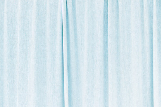 Suspended elegant blue curtain, tulle with folds and waves. Textured background and backdrop with copy space for your text.