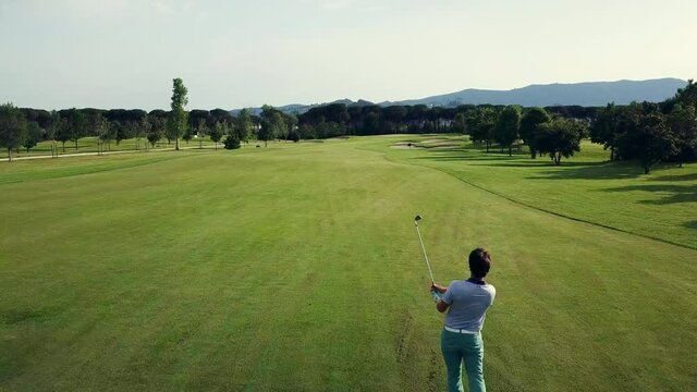 AERIAL WS Men playing golf on sunny day / Prato, Florence, Italy