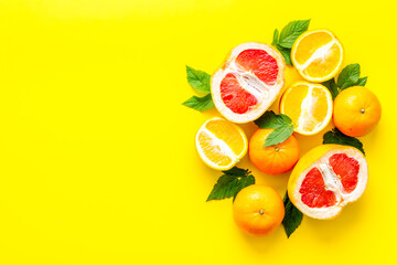 Oranges and grapefruits with leaves on table top view copy space
