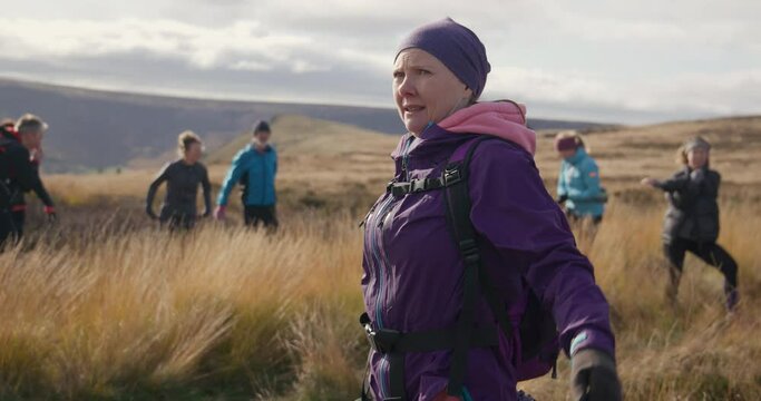 MS Group of hikers warming up in landscape / Yorkshire Moors, Yorkshire, UK