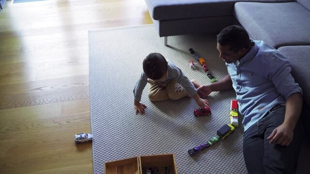 MS HA Father and son (2-3) playing with car toys in living room / Denmark