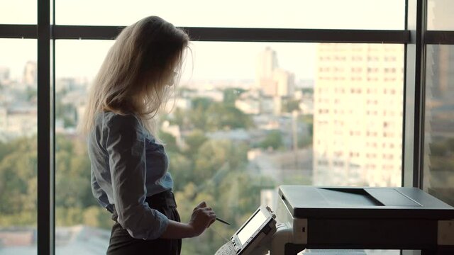 Businesswoman Using Printer In Office.Girl Using Copier For Replicate Paperwork.Woman Preparing Financial Audit Report For Marketing Strategy.Secretary Girl Sending Fax On Email And Printing Document