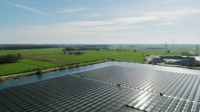 AERIAL WS Solar panels on pond in rural landscape / Zwolle, Overijssel, Netherlands