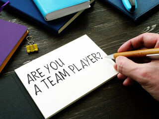 Man writes Are You a Team Player question. Teamwork concept.