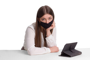 A student woman in a black medical mask and distance learning. Work from home.