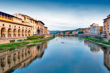 Fototapeta na wymiar Scenic view of the Arno river, the main waterway of Tuscany region running through the medieval city of Florence in Italy