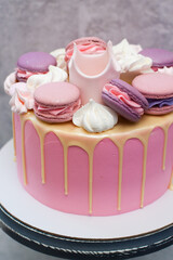 Birthday pink cake for a little girl with fondant crown, melted chocolate, meringue and cake pops...