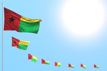 pretty many Guinea-Bissau flags placed diagonal with soft focus and empty place for your text - any occasion flag 3d illustration..