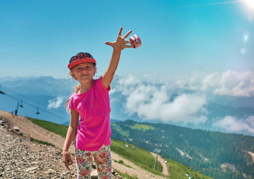 girl playing with yo-yo in the mountains