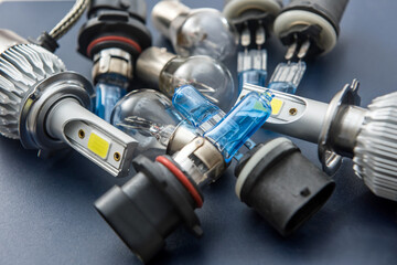 Various Car electric bulbs for parts in headlight on  dark background. many new 12v car filament diod led halogen lamps