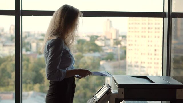 Woman Preparing Financial Audit Report For Marketing Strategy.Businesswoman Using Printer In Office.Girl Using Copier For Replicate Paperwork.Secretary Girl Sending Fax On Email And Printing Document