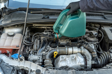 Fototapeta premium mechanic change oil to engine, car servicing