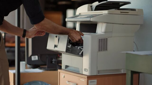 Man Finger Press Buttons On Multifunctional Copier.Man Using Printer Or Scanner In Office.Businessman Printing Document On Workplace.Businessman Working In Office And Preparing Documents For Signature