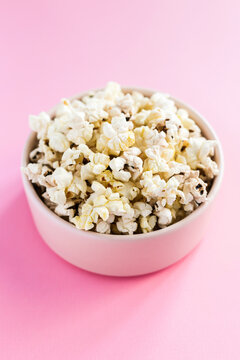 Popcorn In A Pink Bowl On Pink Background 45 Degree Angle Close-up Shot