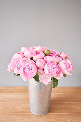 Pink Angel Cheeks peonies in a metal vase. Beautiful peony flower for catalog or online store. Floral shop concept . Beautiful fresh cut bouquet. Flowers delivery