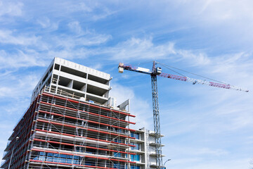 Process of building. Construction site block of flats. High crane industrial background. Sunny day architecture landscape.