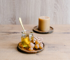 Healthy snack set with muscat grapes, honey and candles on wooden background. 