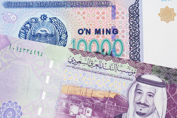 A 10000 som note from Uzbekistan, close up in macro with a 5 riyal bank note from Saudi Arabia