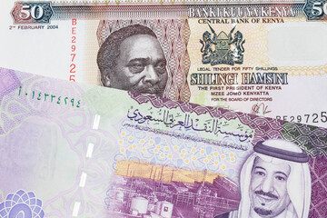A fifty Kenyan shilling note, in macro, close up with a 5 riyal bank note from Saudi Arabia