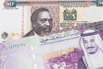 A fifty Kenyan shilling note, in macro, close up with a 5 riyal bank note from Saudi Arabia
