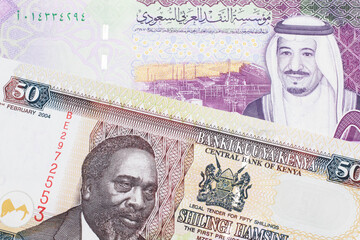 A fifty Kenyan shilling note, in macro, close up with a 5 riyal bank note from Saudi Arabia