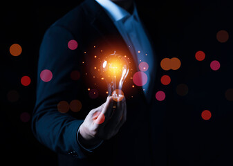 Business man holding light bulbs, ideas of new ideas with innovative technology and creativity and Connection technology concept