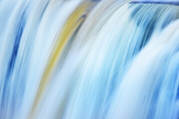 Jagala waterfall texture, Estonia. Close-up, long exposure. Blue and white water splashes. Abstract natural pattern. Environmental conservation, travel destinations, graphic resources