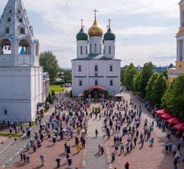 KOLOMNA, MOSCOW REGION, RUSSIA - JUNE 7, 2020: An aerial view of believers observing social distancing in front of the Assumption Cathedral during a religious service.