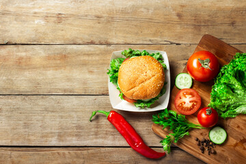 Vegetarian burger. Ingredients for a burger on a wooden background. Copy space, flat lay