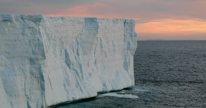 MS PO Giant tabular iceberg in sea at sunset / King George Island, South Shetland Islands, Antarctic Peninsula, Antarctica