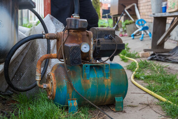 Fototapeta na wymiar the old water pump in the garden 