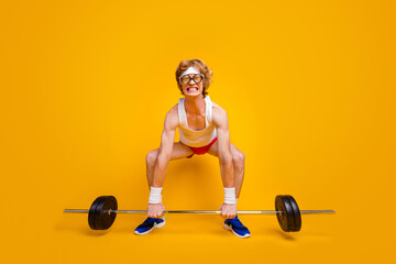 Full length body size view of his he nice funky slim motivated desperate foxy guy lifting barbell doing work out coacher program isolated over bright vivid shine vibrant yellow color background