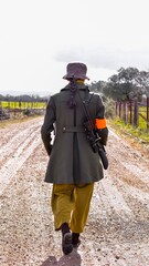Young woman with a rifle returns from hunting in a spanish Montería.