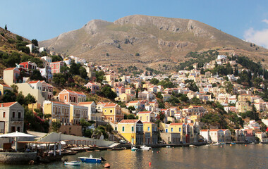 Fototapeta na wymiar Symi town, Symi island, pictorial view of colorful houses and the harbour
